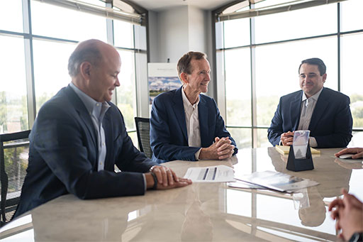 caudle partners businessmen discussing in front of window burfordcaudle family capital